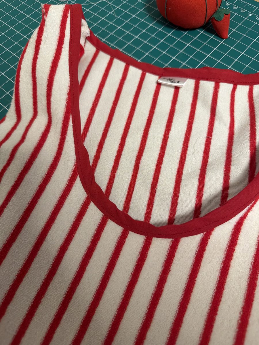 Red bias tape sewn around the neckline of the Solana Dress