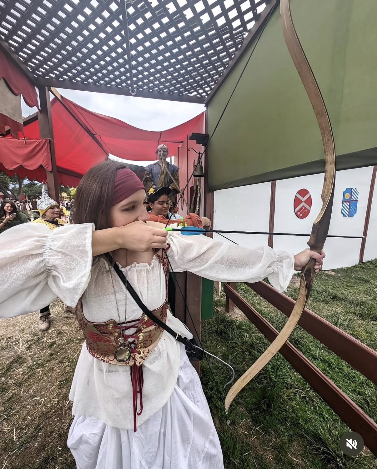 Emily hitting a bullseye with a bow and arrow at the Renaissance Faire