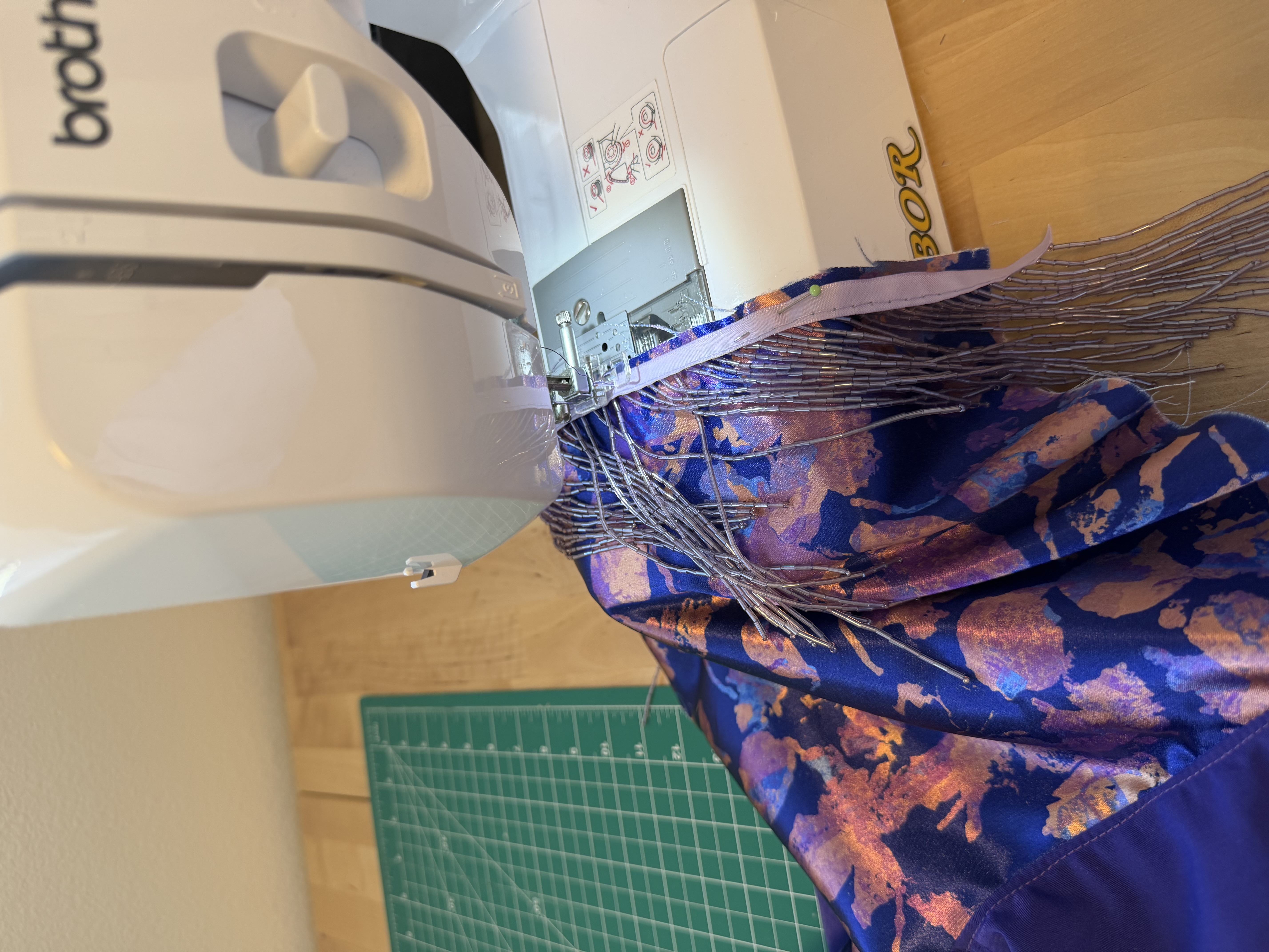 Basting the beaded trim onto the bag