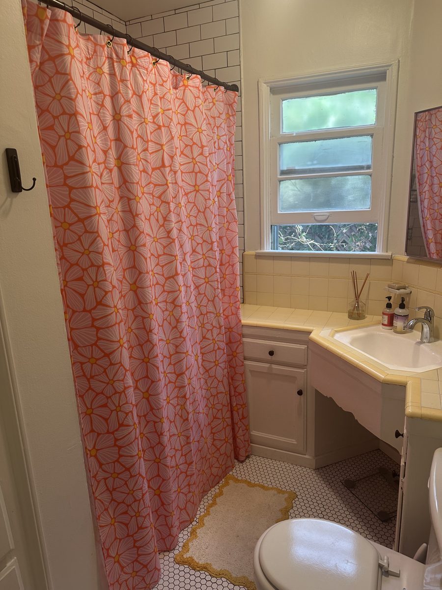 Handmade shower curtain in vintage yellow tile bathroom