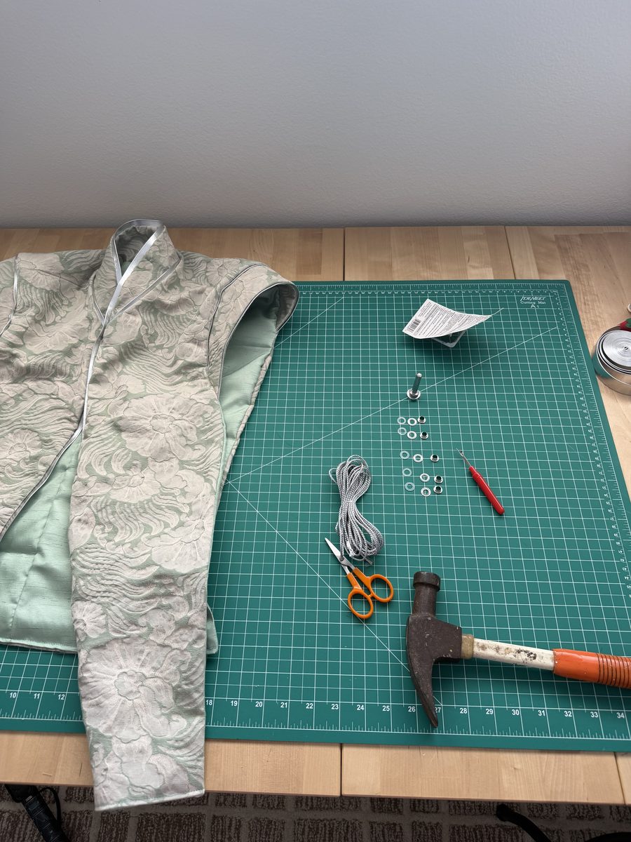 Setting grommets on the lace tabard vest