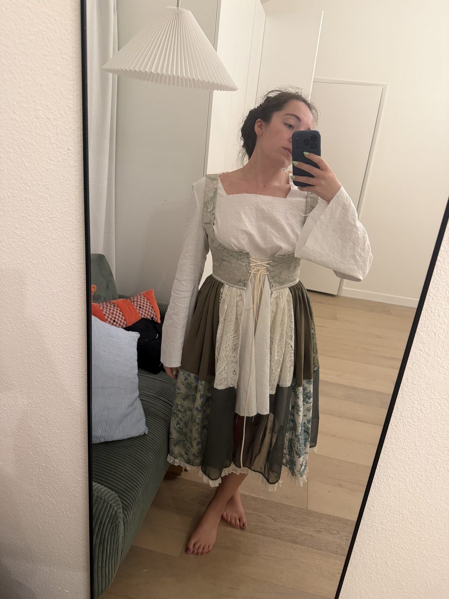Emily trying on the work-in-progress linen dress with the corset duster
