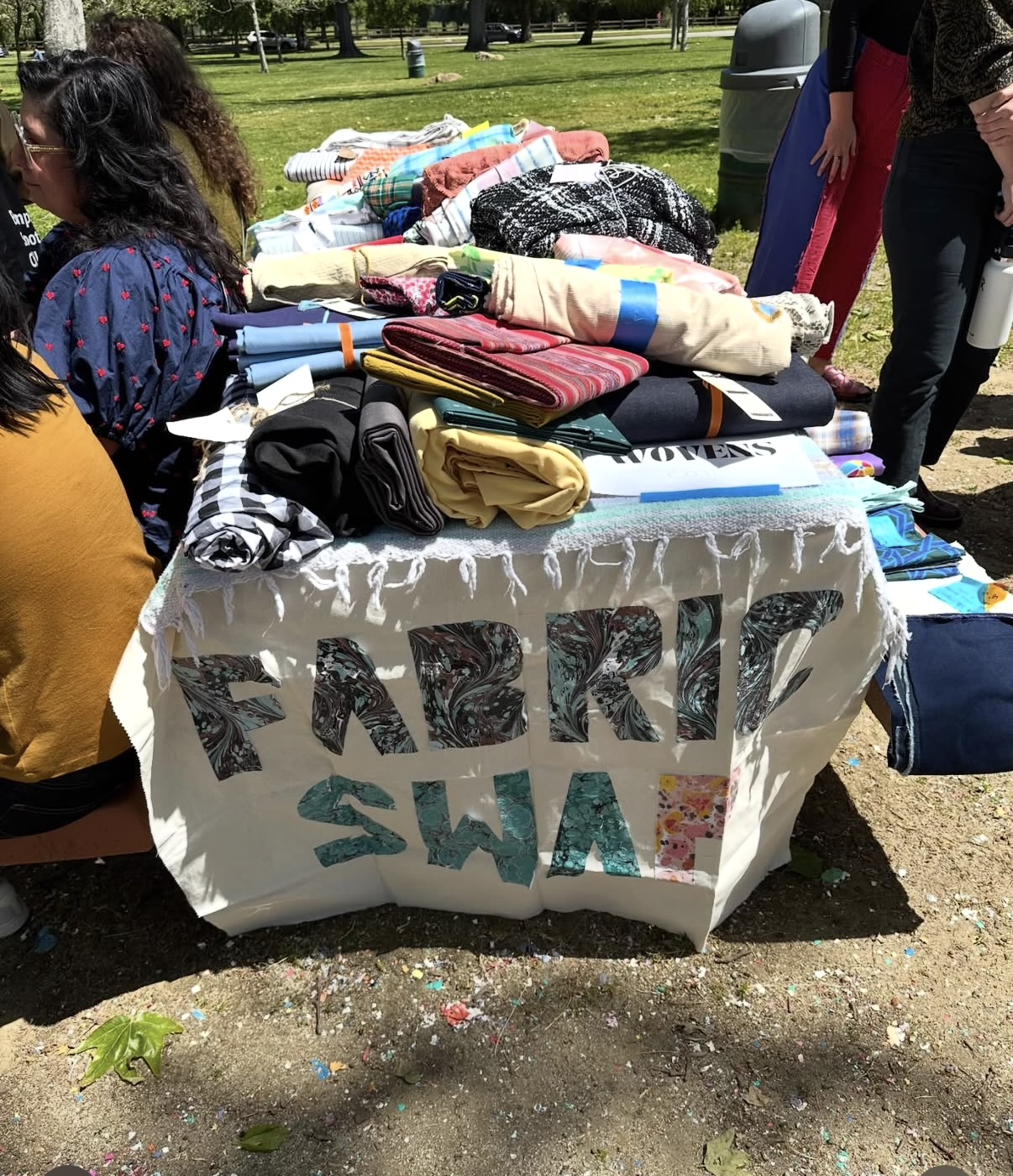 Tables of fabric laid out at the Griffith Park fabric swap
