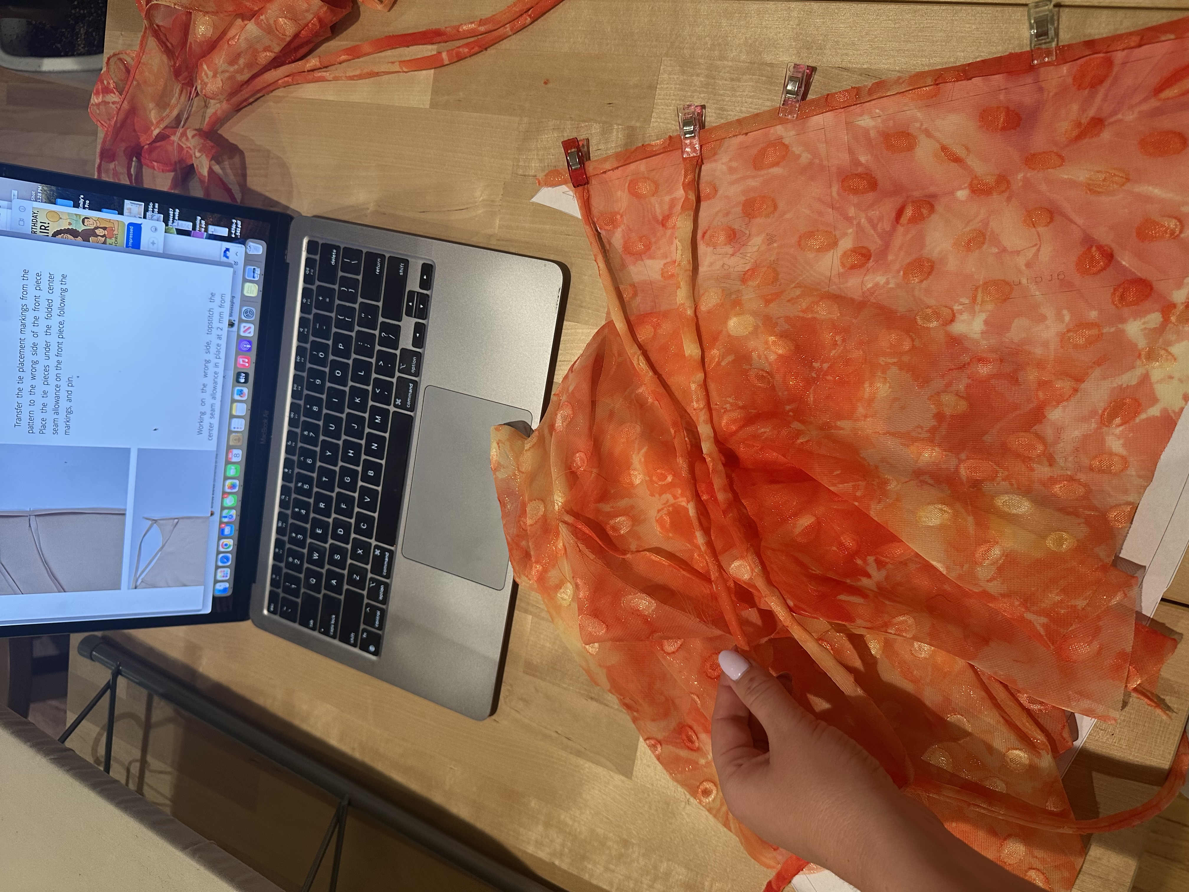 Working on the Jaya Top flounce with the pattern instructions open on a laptop