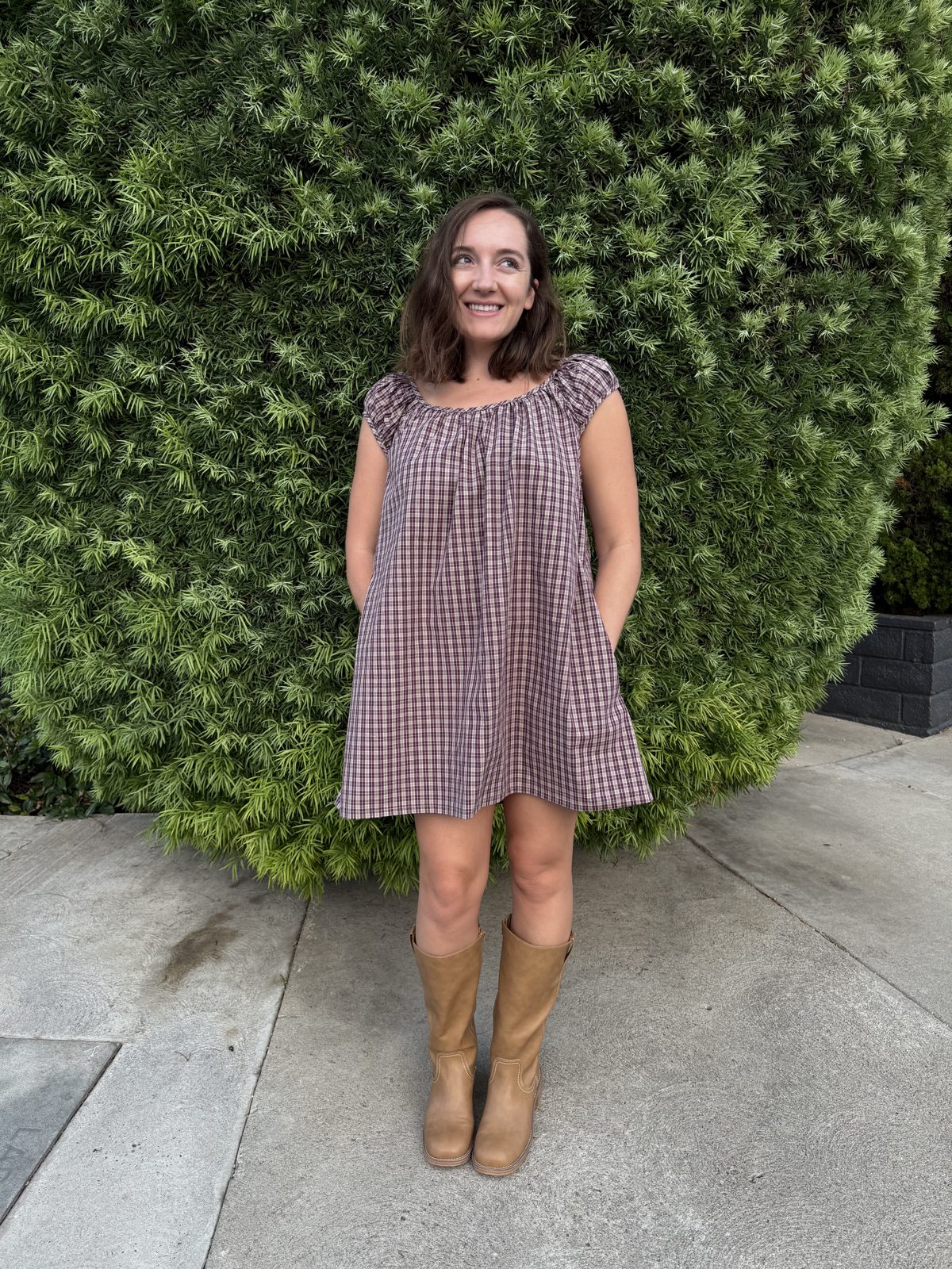 Emily wearing her Linnea mini dress with cap sleeves, sewn in a cotton plaid