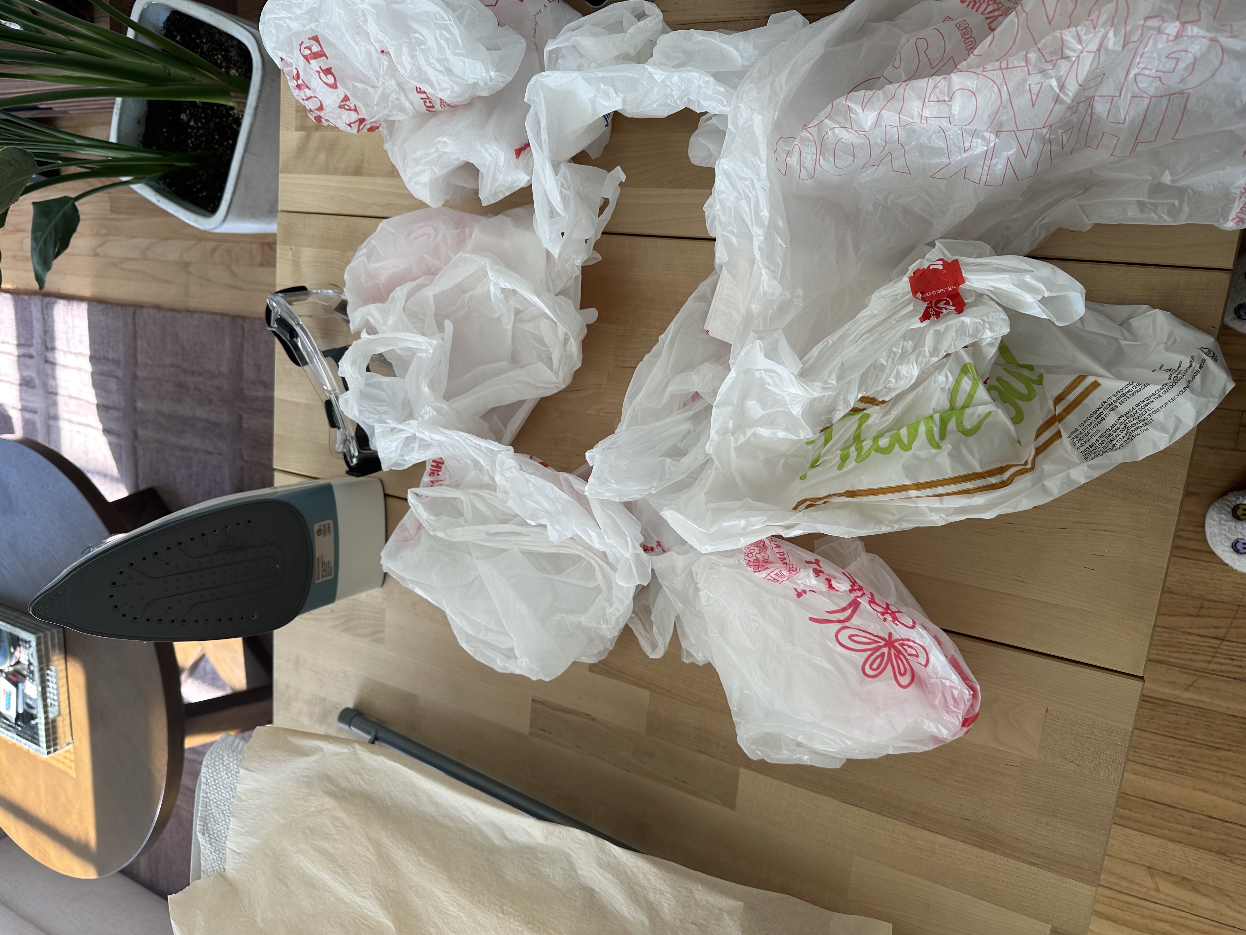A pile of 'thank you' takeout bags saved for upcycling